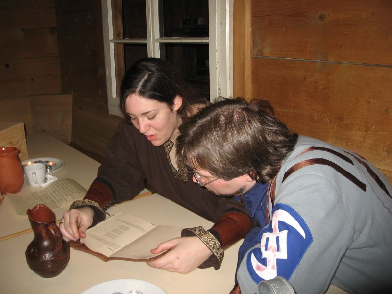 Islin & Victor studying a book full of rituals