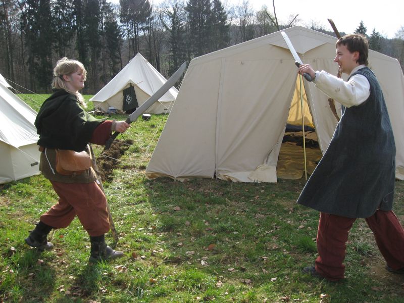 Two cripples practicing sword fighting